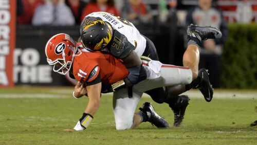Georgia Bulldogs quarterback Greyson Lambert is brought down by Missouri Tigers defensive end Charles Harris during the second half in Athens on Oct. 17, 2015. BRANT SANDERLIN/BSANDERLIN@AJC.COM
