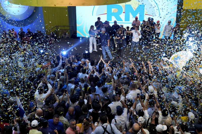 Presidential candidate Jose Raul Mulino, of the Achieving Goals party, center, waves to supporters after winning on the day of the general electing in Panama City, Sunday, May 5, 2024. (AP Photo/Matias Delacroix)