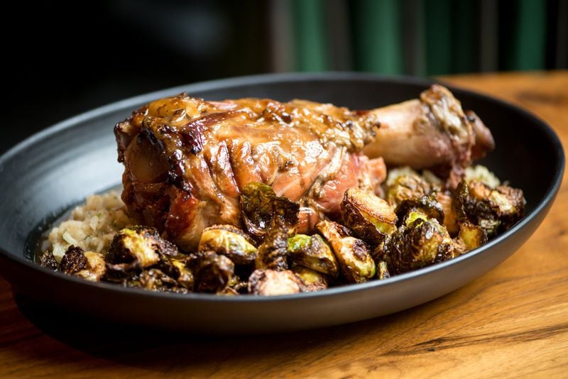 Pork Shank with foie gras dirty rice, Brussels sprouts, and jus. Photo credit- Mia Yakel.