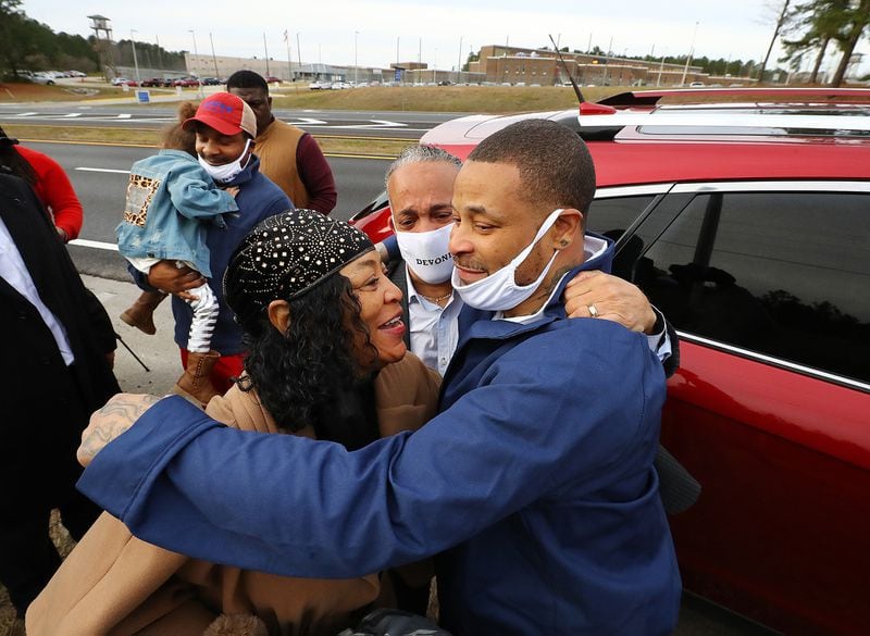Devonia Inman is embraced by his mother, Dinah Ray, and stepfather, David Ray, after being released from custody at Augusta State Medical Prison after serving 23 years of a life sentence. The Legislature did not act this year on his request for compensation in the wrongful conviction. (Curtis Compton/Atlanta Journal-Constitution/TNS)