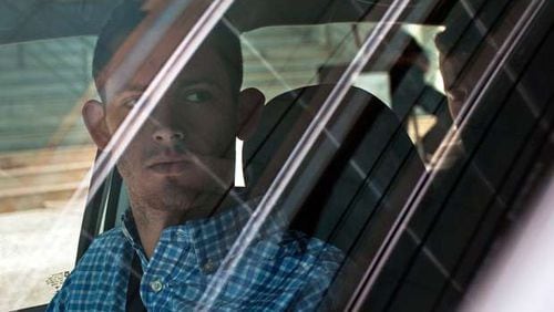 American Olympic swimmers Gunnar Bentz, left, and Jack Conger, in backseat, sit inside a car outside a police station where they were going to provide testimony in Rio de Janeiro, Thursday, Aug. 18, 2016. The two were taken off their flight from Brazil to the U.S. on Wednesday by local authorities amid an investigation into a reported robbery targeting Ryan Lochte and his teammates. A Brazilian police official is telling The Associated Press that American swimmer Lochte fabricated a story about being robbed at gunpoint in Rio de Janeiro. T(AP Photo/Mauro Pimentel)