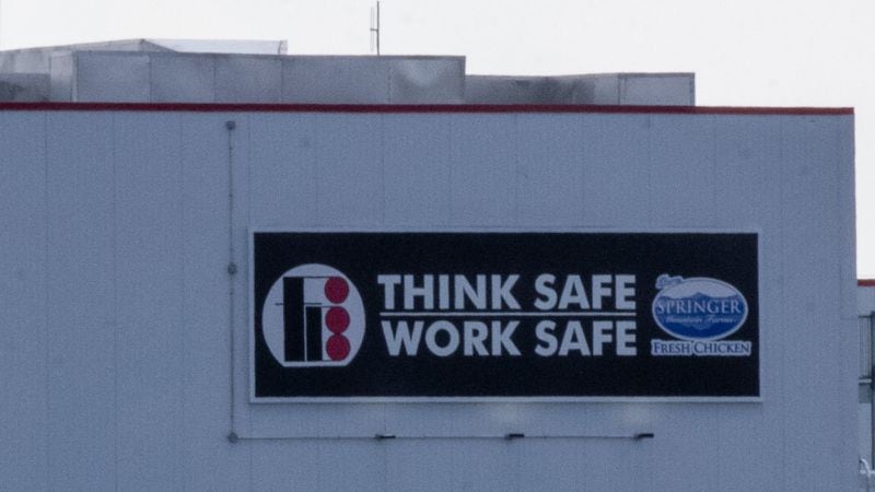 A sign reads "Think Safe, Work Safe" on the Fieldale Farms building in Murrayville, Georgia. (Photo/Rebecca Wright for the Atlanta Journal-Constitution)