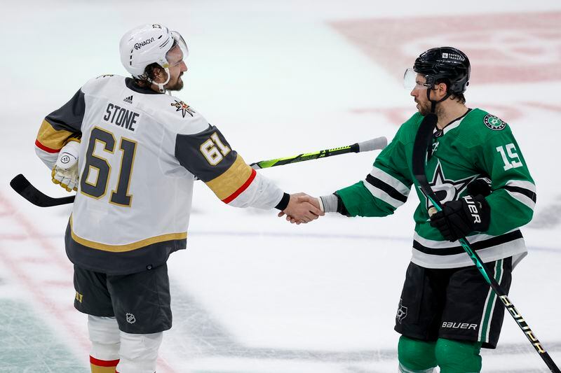 Vegas Golden Knights right wing Mark Stone shakes hands with Dallas Stars center Craig Smith (15) after the Stars won 2-1 in Game 7 of an NHL hockey Stanley Cup first-round playoff series, Sunday, May 5, 2024, in Dallas. (AP Photo/Brandon Wade)