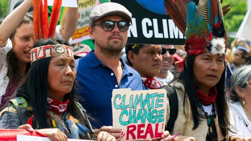 Actor Leonardo DiCaprio (2nd L) marches with a group of indigenous people from North and South America, during the People's Climate March in Washington DC, on April, 29, 2017. (Photo by JOSE LUIS MAGANA/AFP/Getty Images)