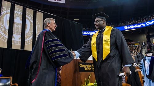 Former Georgia Tech offensive lineman Shamire Devine accepts congratulations from school president G.P. "Bud" Peterson at the school's commencement exercises last Saturday.
