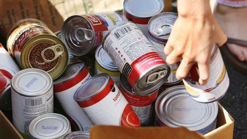 A volunteer sorts some of the cans of food donated to North Fulton Community Charities. Photo credit: Bob Andres