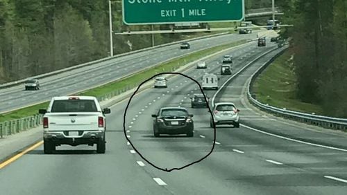 DeKalb County police are seeking the dark car in the circle in connection with a deadly road-rage shooting. (Credit: DeKalb County Police Department)
