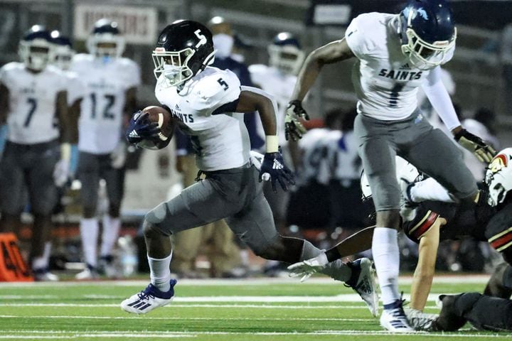 Oct. 23, 2020 - Norcross, Ga: Wearing a mask, Cedar Grove running back Langston White (5) gets past a GAC defender for yardage in the second half at Greater Atlanta Christian, Friday, October 23, 2020 in Norcross, Ga.. Cedar Grove won 33-6. JASON GETZ FOR THE ATLANTA JOURNAL-CONSTITUTION