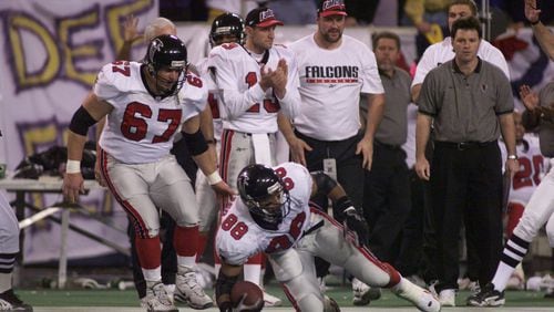 O.J. Santiago gets up after a 26-yard reception which was the third play of the Falcons final drive. (BEN GRAY/STAFF)
Atlanta Falcons quarterback Chris Chandler (cq) scrambles past the Vikings Tony Williams (cq) during the Falcons' final scoring drive in overtime. (BEN GRAY/STAFF)