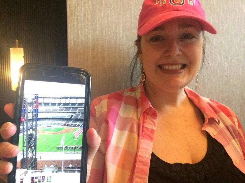 On her way to SunTrust Park to take in Thursday's Opening Day Braves game,  Cheyenne Brinson paused to show a photo she'd taken of the view through the window of her 11th floor room at the Omni Hotel at the Battery Atlanta. Jill Vejnoska/AJC