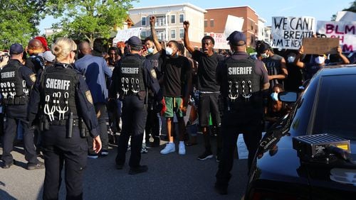 Protesters and police face off on South Clayton Street a few blocks from Lawrenceville City Hall as protests continue for a fourth day around metro Atlanta over the death of George Floyd on Monday, June 1, 2020, in Lawrenceville. Curtis Compton ccompton@ajc.com