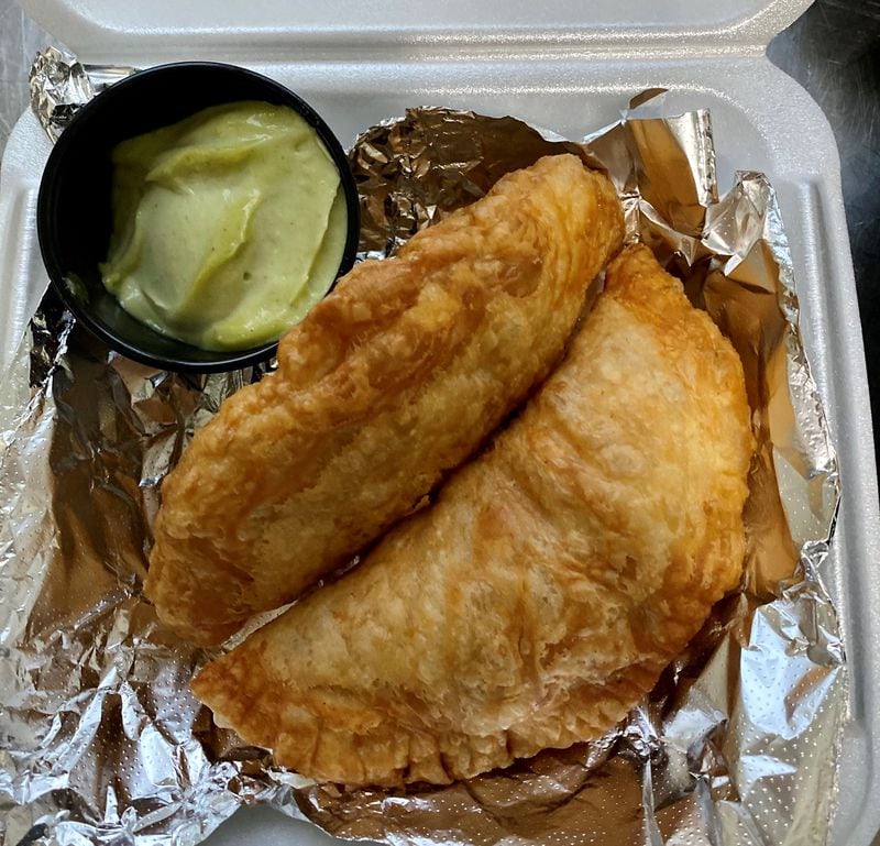 Lean Draft House chef Pedro Suastegui makes terrific fried empanadas in wonderfully flaky shells; these are stuffed with carnitas. Wendell Brock for The Atlanta Journal-Constitution