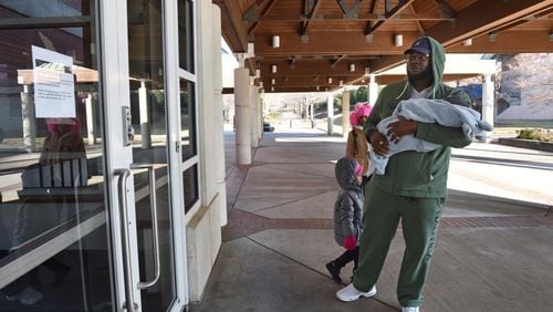 Javaris Green Sr., of St. Petersburg, Fla., holding his 3 months-old son Javaris Green Jr., can't hide his disappointment as he finds out Martin Luther King Jr. National Historical Park site is closed due to a government shutdown on Saturday, Dec. 22, 2018. (Photo: HYOSUB SHIN / HSHIN@AJC.COM)