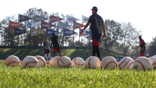 Baseballs cover the field in the early morning light during spring training at Disney’s ESPN Wide World of Sports. The Braves are seeking to move their spring home from Disney to Sarasota County in 2019. (Curtis Compton/ccompton@ajc.com)