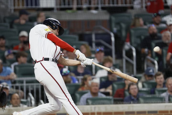 Braves first baseman Matt Olson (28) hits a solo home run during the bottom of the seventh inning against the Colorado Rockies at Truist Park. Miguel Martinez / miguel.martinezjimenez@ajc.com 