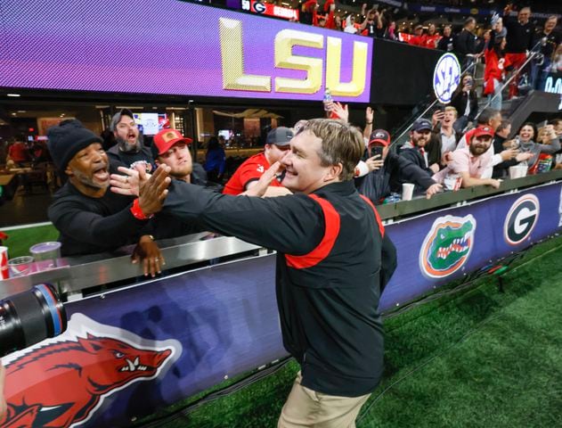 Georgia Bulldogs head coach Kirby Smart celebrates with fans after UGA defeated LSU 50 - 30 in the SEC Championship between the Georgia Bulldogs and the LSU Tigers In Atlanta on Saturday, Dec. 3, 2022. (Bob Andres / Bob Andres for the Atlanta Constitution)