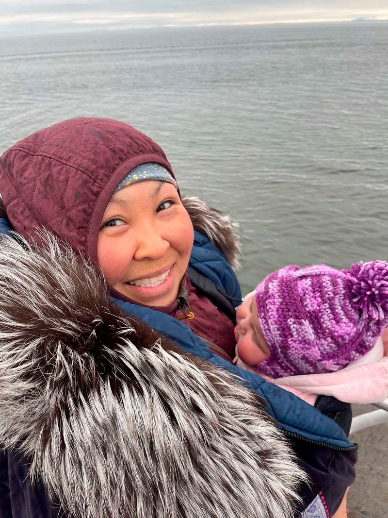 In this photo provided by Kristin Paniptchuk, she holds her daughter, Kinley, in Shaktoolik, Alaska, on May 23, 2023. The Alaska Air National Guard rescued Paniptchuk in the Inupiat village of Shaktoolik, on Dec. 29, 2022, when an air ambulance couldn't land in bad weather. Personnel changes implemented at the national level may force the Alaska Air National Guard to greatly reduce the number of civilian search-and-rescue missions it conducts. (Courtesy of Kristin Paniptchuk via AP)