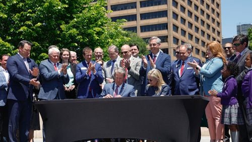 Gov. Brian Kemp signs Senate Bill 233, known as the Georgia Promise Scholarship Act, at Liberty Plaza on Tuesday, April 23, 2024. (Natrice Miller/ AJC)
