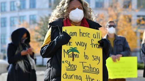 December 15, 2020 Atlanta -  Renee O'Connor, holds a sign during a protest to urge a stop of standardized testing during the COVID-19 pandemic, at Liberty Plaza in Atlanta on Tuesday, December 15, 2020. (Hyosub Shin / Hyosub.Shin@ajc.com)