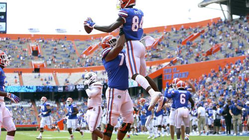 Florida tight end Kyle Pits (84) leaps up as he celebrates a touchdown catch with teammates during an NCAA college football game against South Carolina in Gainesville, Fla., Saturday, Oct. 3, 2020. (Brad McClenny/The Gainesville Sun via AP, Pool)