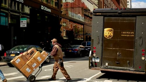 Sandy Springs-based UPS and the International Brotherhood of Teamsters reached a deal this week on a new labor contract to avert a massive strike. (Gabby Jones/The New York Times)