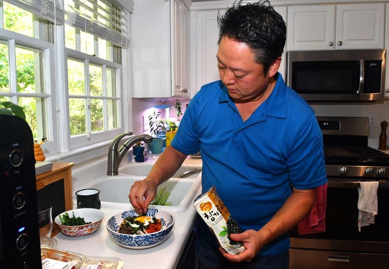 Chef Todd Dae Kulper adds a crunchy seaweed snack to his bibimbap, a Korean rice dish prepared with marinated meat and vegetables. Chris Hunt for The Atlanta Journal-Constitution 