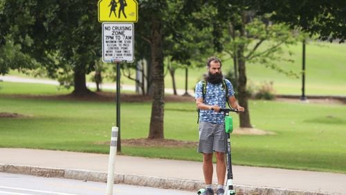 A man rides a scooter by Piedmont Park in Atlanta on Wednesday, July 18, 2019.Christina Matacotta/Christina.Matacotta@ajc.com