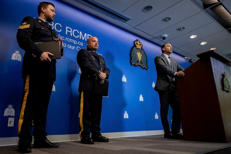 Superintendent Mandeep Mooker, right, Officer-in-Charge of IHIT speaks to media with Assistant Commissioner David Teboul, centre, during a news conference for an update on the Hardeep Singh Nijjar homicide investigation from June 18, 2023, in Surrey, B.C., Friday, May 3, 2024. (Ethan Cairns/The Canadian Press via AP)