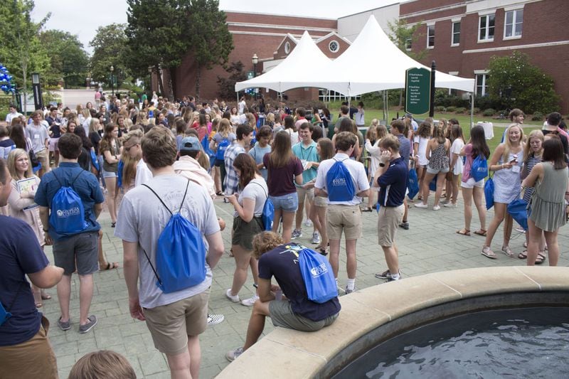 Students and parents gather around the fountain at Georgia College for an orientation session in 2018. AJC FILE PHOTO.