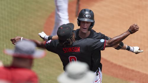 Georgia’s Charlie Condon celebrates after hitting a solo home run with Georgia’s Josh Stinson (0) during the first inning against Army in the NCAA division I baseball Athens Regional at Foley Field, Friday, May 31, 2024, in Athens, Ga. Georgia won 8-7. (Jason Getz / AJC)

