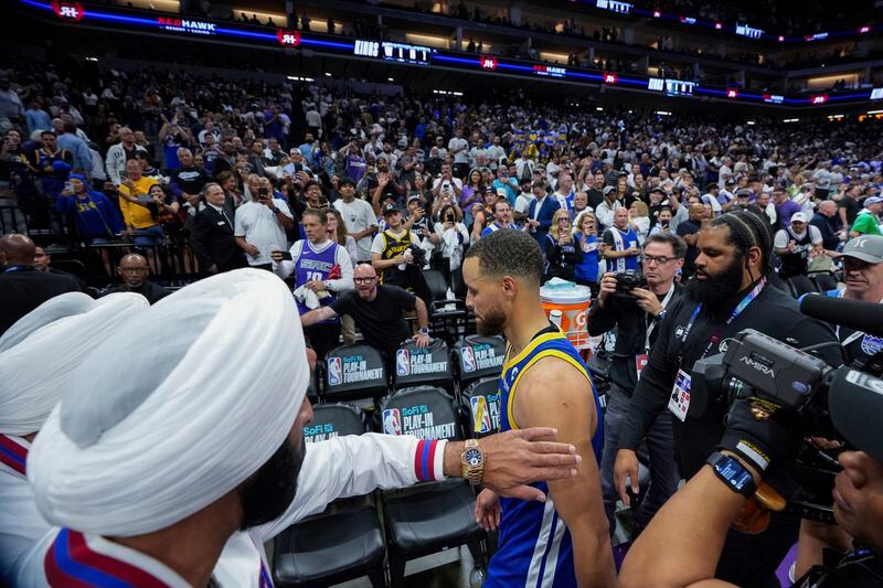 Golden State Warriors guard Stephen Curry, center, leaves the court after the team's loss to the Sacramento Kings in an NBA basketball play-in tournament game Tuesday, April 16, 2024, in Sacramento, Calif. (AP Photo/Godofredo A. Vásquez)