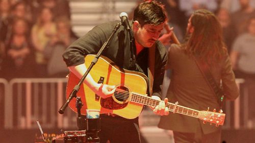 Marcus Mumford leans into a song during the sold-out March 20 Mumford & Sons concert at State Farm Arena. Photo: Melissa Ruggieri/Atlanta Journal-Constitution