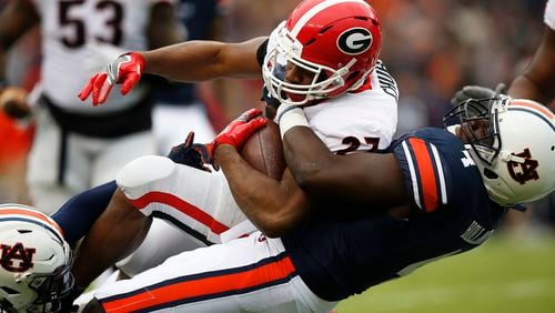Georgia running back Nick Chubb is tackled by Auburn linebacker Jeff Holland during the first half Nov. 11, 2017,  in Auburn, Ala. Just three weeks after Auburn romped to a 23-point victory, the No. 4 Tigers face a rematch against No. 6 Georgia in the Southeastern Conference championship game. (Brynn Anderson/AP)