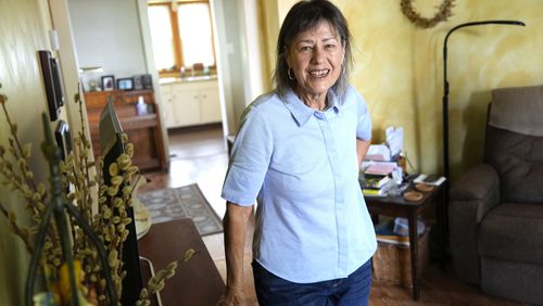 Susan Pryce stands in the living room of her Derry, Pa., home on, Saturday, May 11, 2024. A Democratic group is rolling out a new $140 million ad campaign this week that aims to chip away at Donald Trump’s support among one of his most loyal voting blocs: rural voters. Pryce, 74, a retired nurse, has offered a litany of reasons why she does not support Trump, from his comments maligning the late Sen. John McCain, a former prisoner of war, to his history of bragging about sexually abusing women. (AP Photo/Gene J. Puskar)