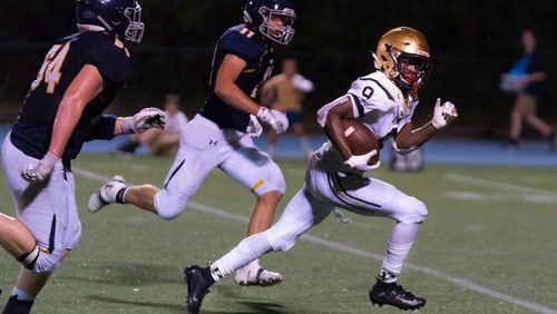 St. Pius running back Jason Jones (9) breaks free against the Marist defense in the second half of Friday's game. (Drew Dinwiddie/Special)