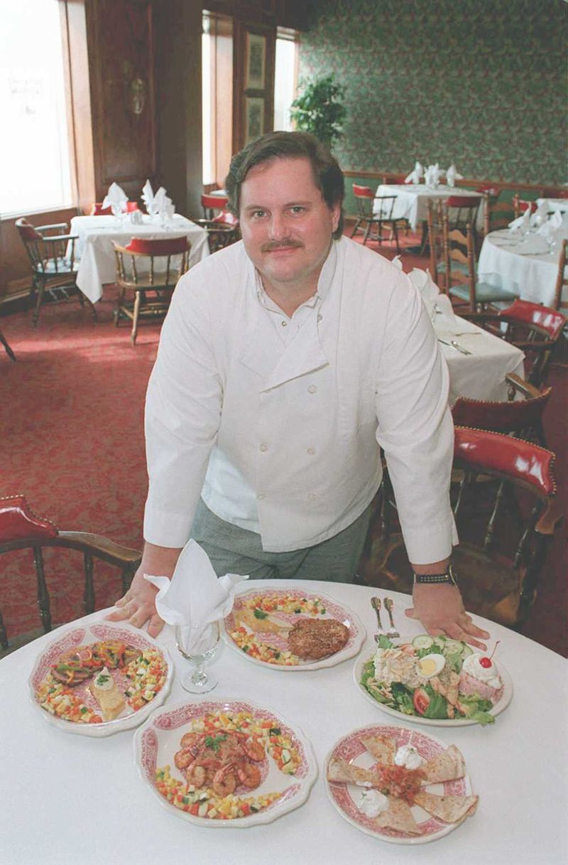 Paul Conway Executive Chef at the Top of the Plaza restaurant in Decatur with some menu selections from his restaurant. Clockwise from top, the second dish is a re-creation of Rich’s Magnolia Room dish with Chicken Salad Amandine and Frozen Fruit Salad. AJC file