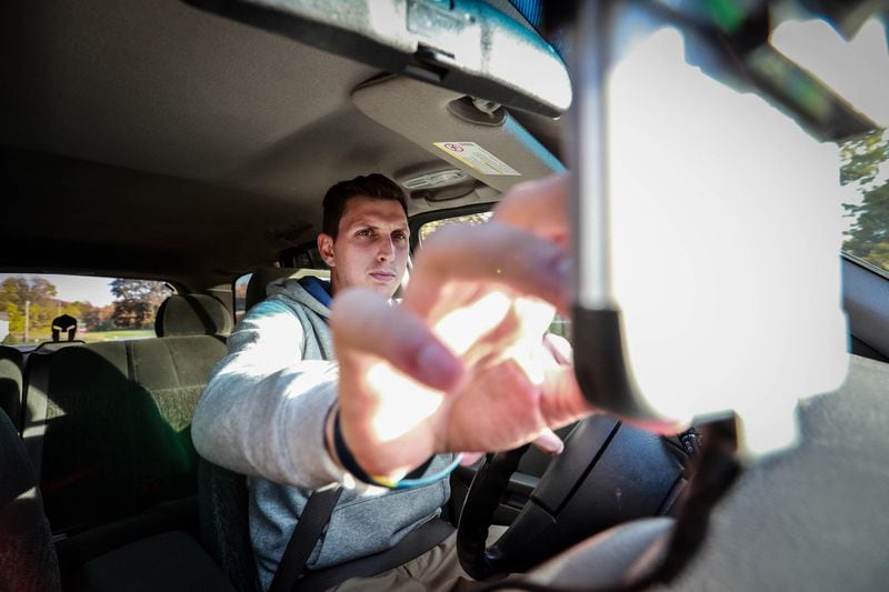 Brett Hudson from Jackson, Mich., drives a 2002 Chevy Trailblazer on Nov. 1, 2016. To reduce the time he looks at the phone, Hudson installed an aftermarket Bluetooth system for hands-free phone calls. Highway deaths have surged in the last two years, and experts put much of the blame on in-car use of smartphones and dashboard apps. (Fabrizio Costantini/The New York Times)