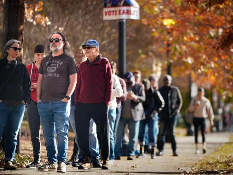 Voters at the Joan P. Garner library line up out the door and down the road as early voting is in full swing in Fulton county on Nov. 28, 2022. (Ben Hendren for the Atlanta Journal Constitution) 