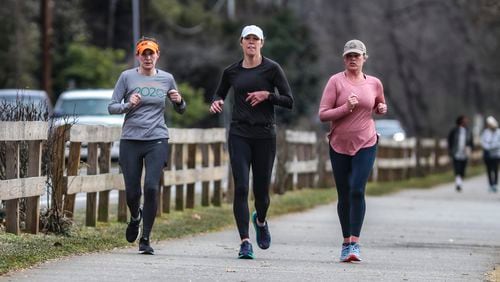 Mary Lynn Kidd, Susan Cochran and Jackie Cozzo (left to right) ran along Azalea Drive in Roswell in January as temperatures headed into the upper 50s. New projections show that Georgia is likely to experience warmer than average temperatures over the next three months.  (John Spink / John.Spink@ajc.com)