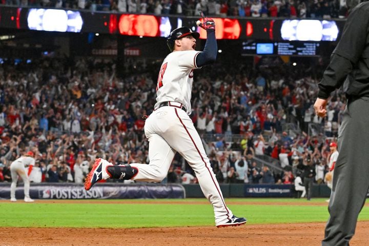 Atlanta Braves’ Austin Riley (27) celebrates a two-run home run against the Philadelphia Phillies during the eighth inning of NLDS Game 2 in Atlanta on Monday, Oct. 9, 2023.   (Hyosub Shin / Hyosub.Shin@ajc.com)