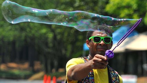 Performer Judah Andrews makes bubbles at the Peachtree Corners Festival Saturday June 30, 2012. Peachtree Corners will begin operation as a city July 1, 2012, the first new city in Gwinnett County in 56 years.