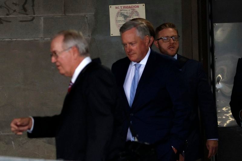 After hours of testimony, Mark Meadows, middle, the former White House chief of staff, is seen leaving the federal court in Atlanta on Aug. 28, 2023. He appeared in an Atlanta courtroom to attempt the transfer of his Fulton County racketeering case to federal court. (Miguel Martinez/The Atlanta Journal-Constitution/TNS)