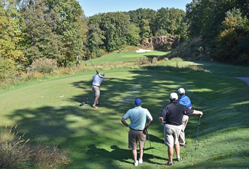 One challenge for private clubs is how to keep members engaged when games are long and time is short. Bill Turner, a guest at The Standard Club in Johns Creek, hits his driver on the No. 18 hole as other members and guests watch. HYOSUB SHIN / HSHIN@AJC.COM