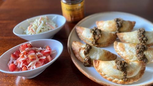 To go with its savory pastries, Besties has creamy cole slaw and tomato salad with onions and oregano. Wendell Brock for The Atlanta Journal-Constitution