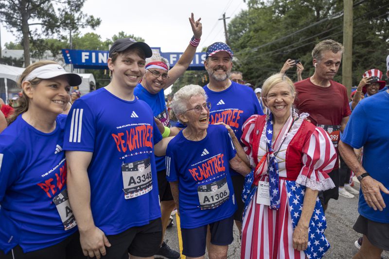 Betty Lindberg, 98, crosses the finish line of the 54th running of the Atlanta Journal-Constitution Peachtree Road Race in Atlanta on Tuesday, July 4, 2023.  Lindberg set the 5K World record in 2022 in the 95-99 age group. (Jason Getz / Jason.Getz@ajc.com)