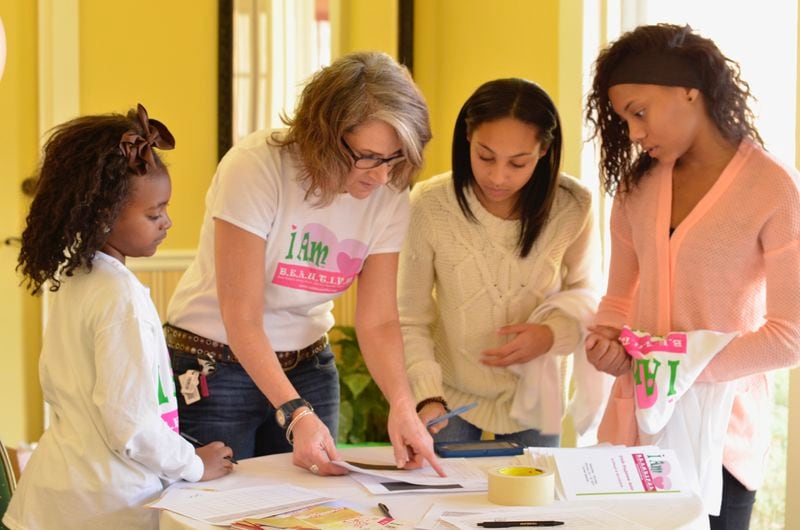 Longtime volunteer Amy Riker is seen here (second from left) working with B.E.A.U.T.I.F.U.L. Beacons during a STEM workshop. Volunteers are the cornerstone of I Am B.E.A.U.T.I.F.U.L., Zenobia Edwards said. CONTRIBUTED
