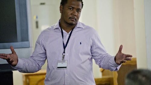 Omar Howard (shown in 2014) speaks with residents of the Atlanta Transitional Center. Howard, once an inmate in a correctional facility himself, is now a chaplain and motivational speaker. JONATHAN PHILLIPS / SPECIAL
