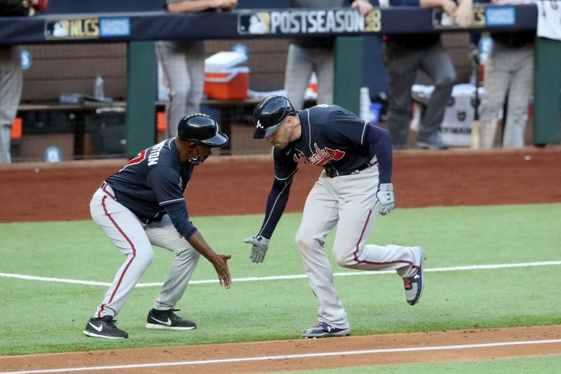 Braves first baseman Freddie Freeman celebrates his two-run homer with third base coach Ron Washington during the fourth inning of Game 2 of the NLCS Tuesday, Oct. 13, 2020, at Globe Life Field in Arlington, Texas. (Curtis Compton / Curtis.Compton@ajc.com)



