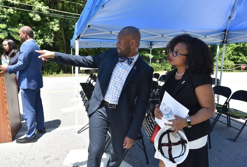 Davion Lewis (left), executive director, and Candace Tate (right), board chair for Latin Grammar School, talk during the RISE Schools groundbreaking ceremony at Latin Grammar School and Latin College Preparatory School in East Point on Friday, June 29, 2018. HYOSUB SHIN / HSHIN@AJC.COM
