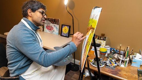 Wellstar cancer surgeon, Dr. Sahir Shroff, works on a painting in his studio at his Marietta home. He never thought his journey to medicine would lead him to find a passion for art-- referring to this moment as a "serendipitous encounter with painting."  PHIL SKINNER FOR THE ATLANTA JOURNAL-CONSTITUTION